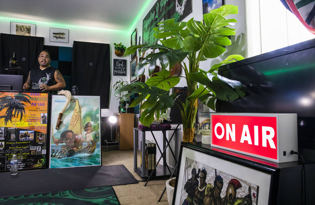 Paul Pu'ukani Sebala in his home radio studio, which is full of native Hawaiian paraphernalia a ...
