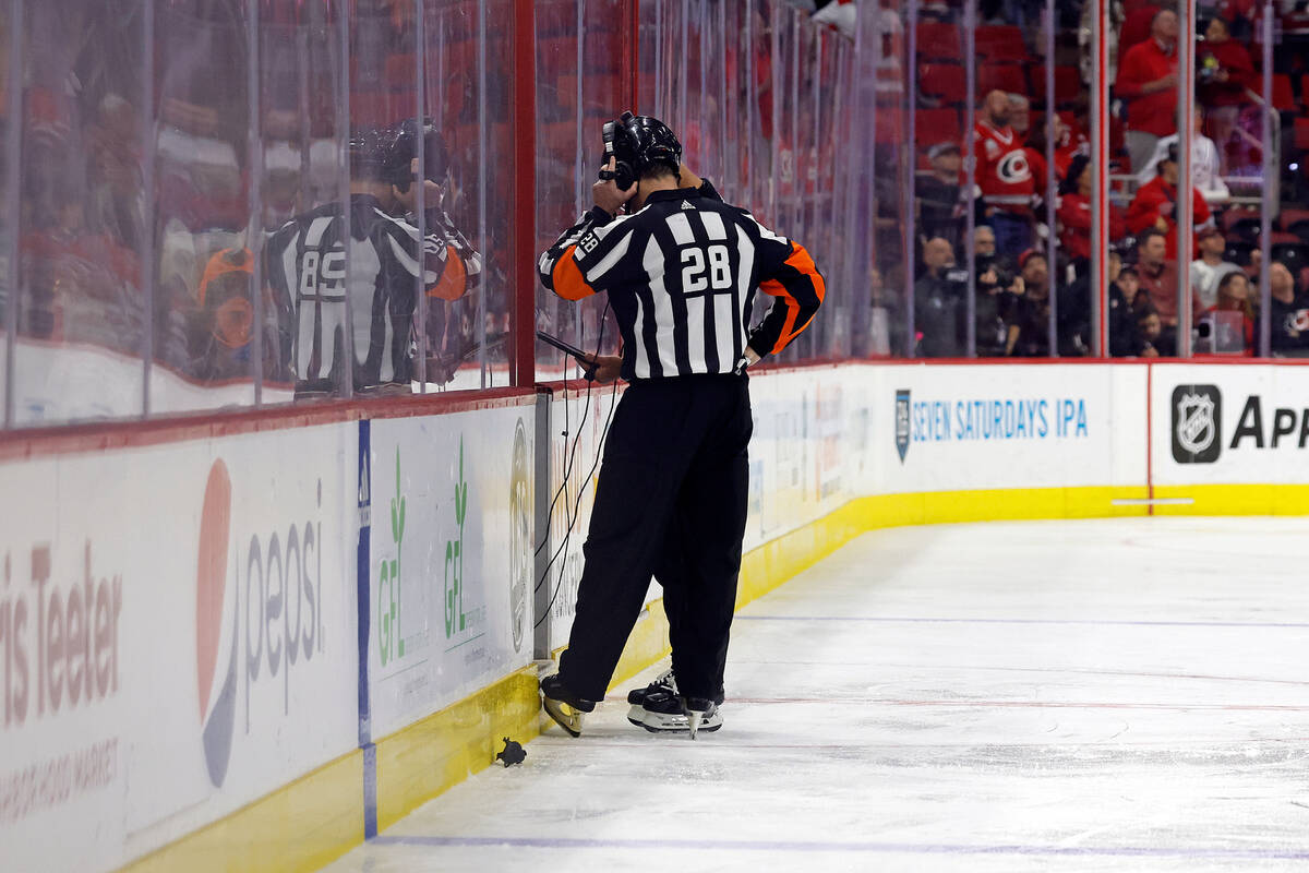 Referee Chris Lee (28) talks to league officials reviewing an apparent goal by Florida Panthers ...