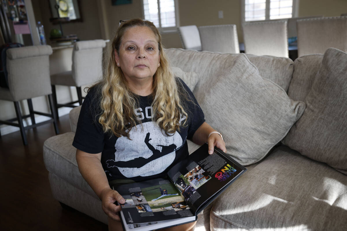 Mariela Azarpira holds a Northwest Career and Technical Academy yearbook in her house Thursday, ...