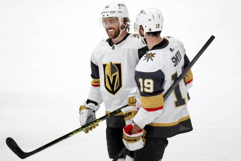 Golden Knights right wing Jonathan Marchessault (81) and right wing Reilly Smith (19) chat in b ...