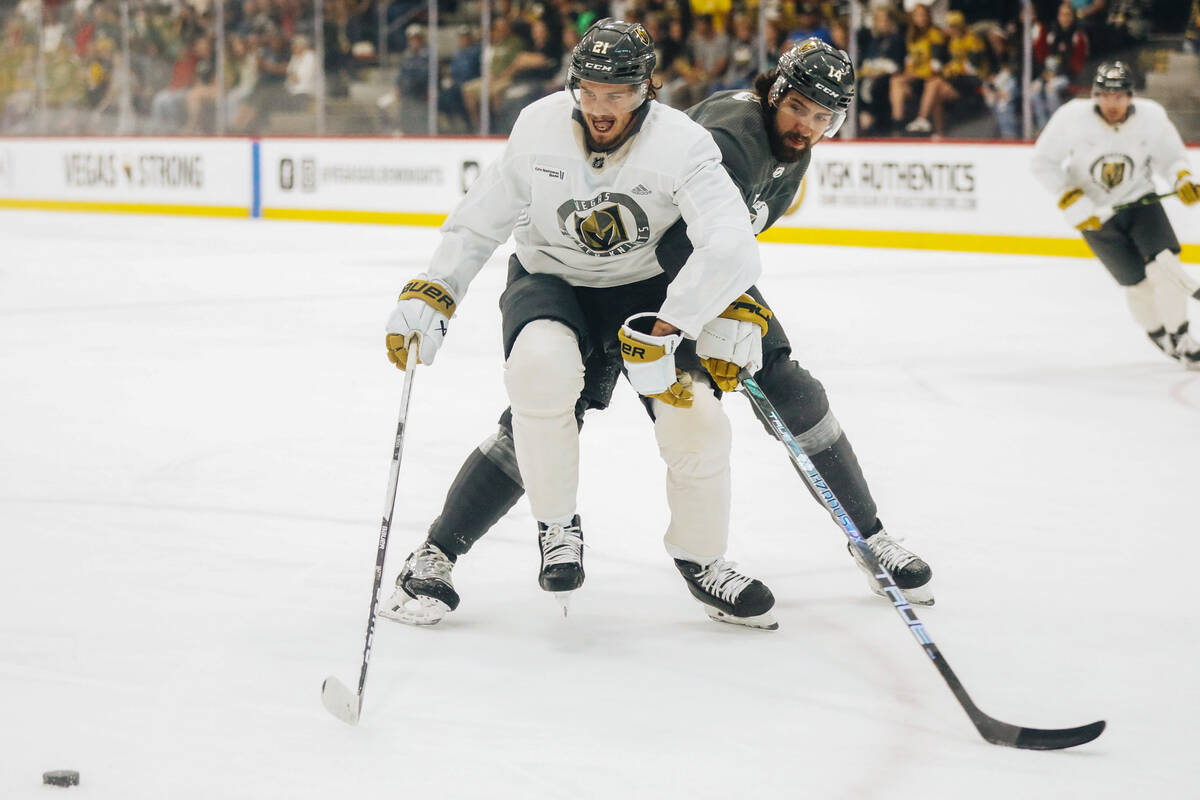 Golden knights center Brett Howden, front, chases after the puck as defenseman Nicolas Hague cl ...