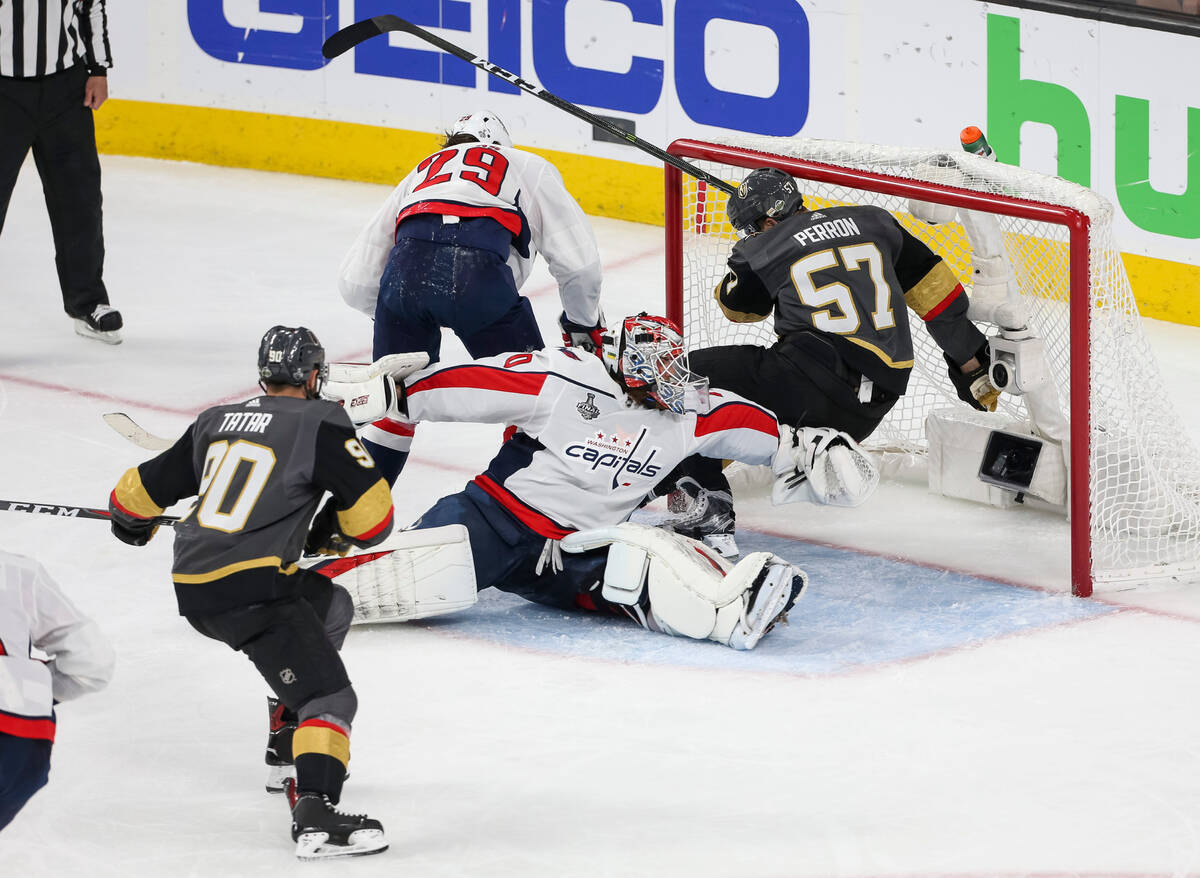 Golden Knights left wing David Perron (57) falls into the net after colliding with Washington C ...