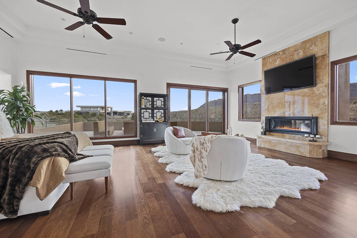 A private upper-level primary suite boasts a fireplace with Onyx surround, fitness area, separa ...