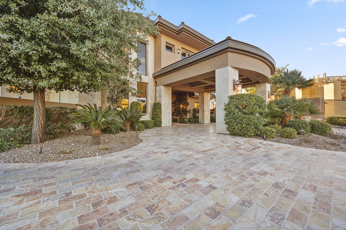 The three-level estate has six en suite bedrooms, formal living and dining, an executive office ...