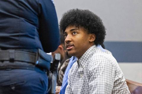 UNLV basketball recruit Zaon Collins, right, waits to appear in court during a preliminary hear ...