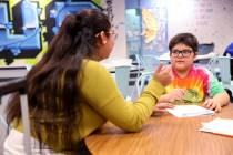 Jerania Mancilla, assistant teacher for resource room, works with fourth grader Daniel Gomez Ro ...