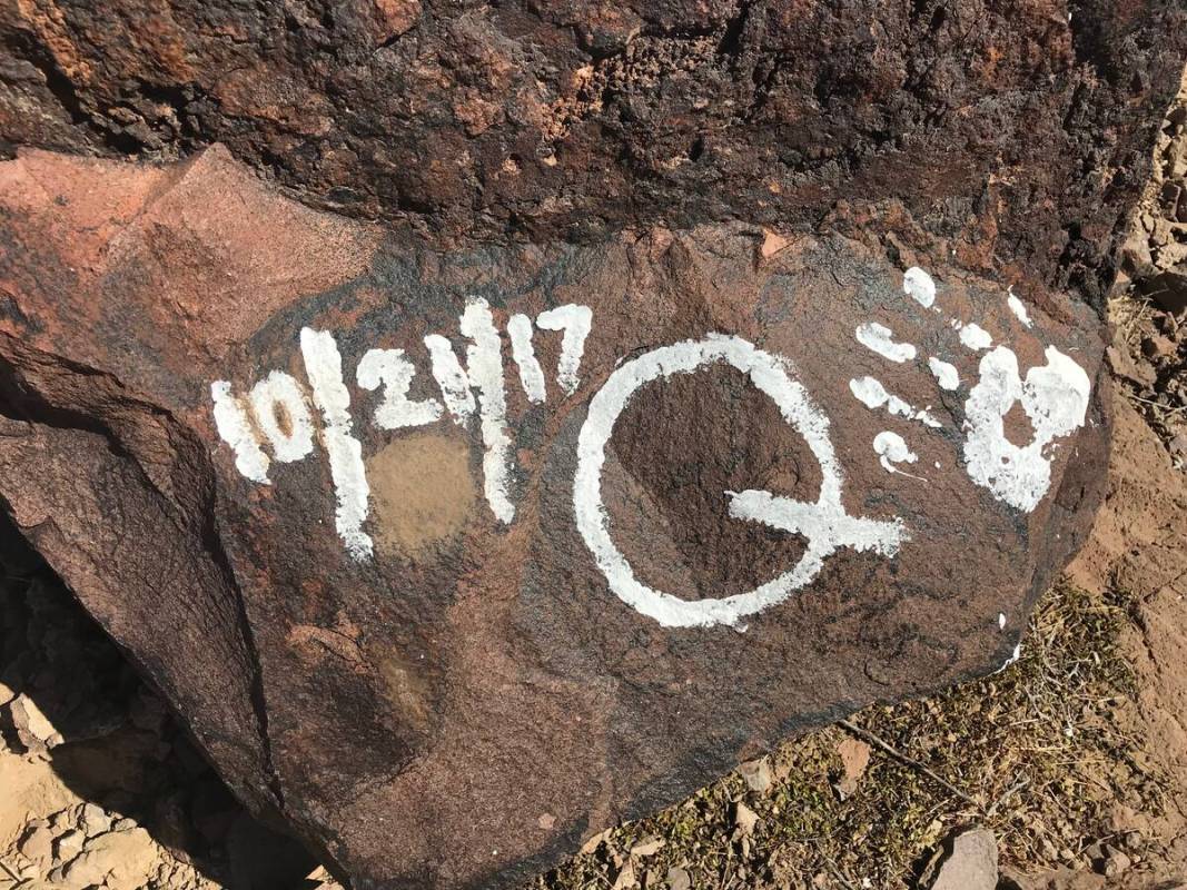 Messages and handprints are left on a rock just below a giant Q in honor of Quinton Robbins on ...