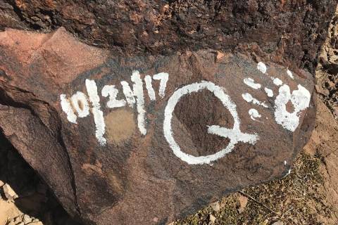 Messages and handprints are left on a rock just below a giant Q in honor of Quinton Robbins on ...
