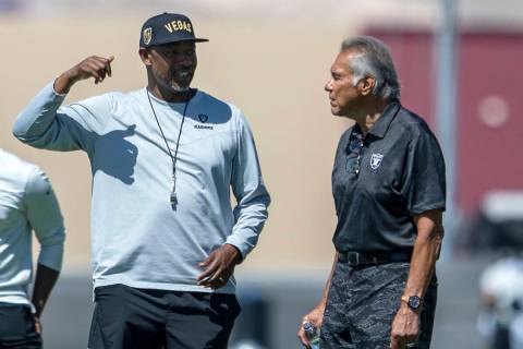Raiders defensive coordinator Patrick Graham, left, speaks with former Raiders quarterback Jim ...