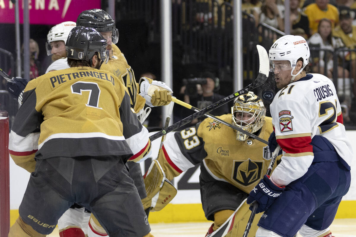 The puck hits Florida Panthers center Nick Cousins (21) in the face while Golden Knights defens ...