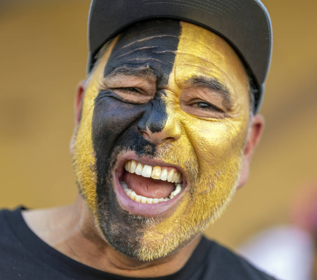Golden Knights fan Paul Sanchez of San Antonio yells with his face painted outside before the s ...