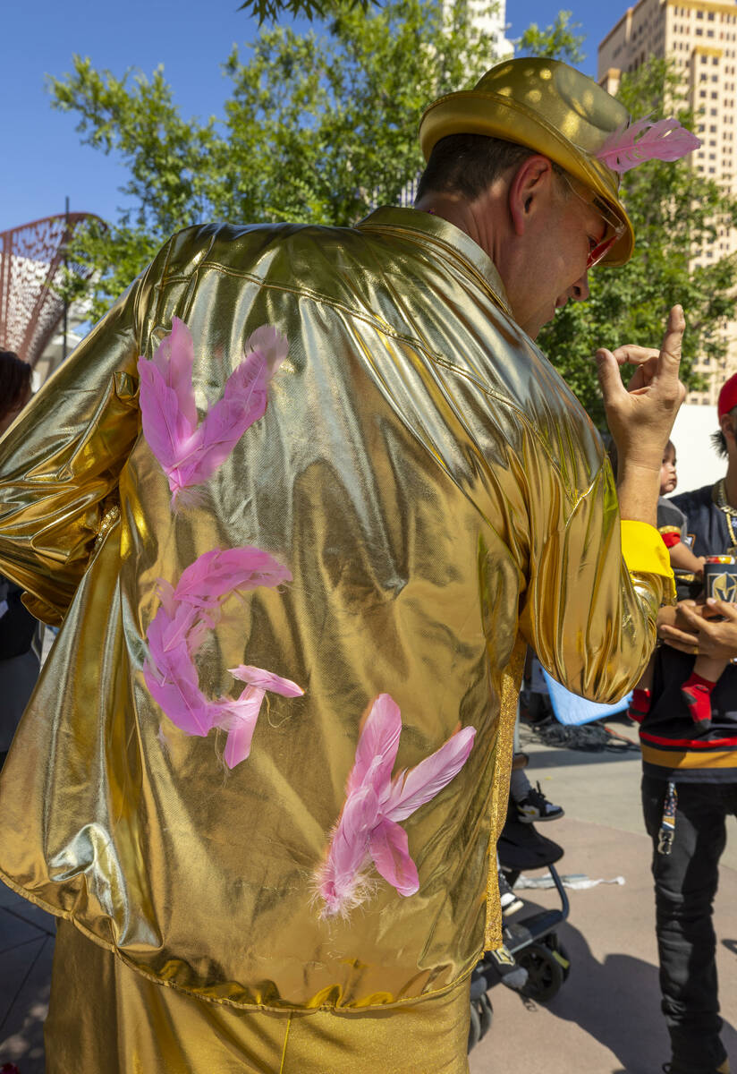 Golden Knights fan Russ Kuch of Las Vegas shows off his custom gold jacket outside before the s ...