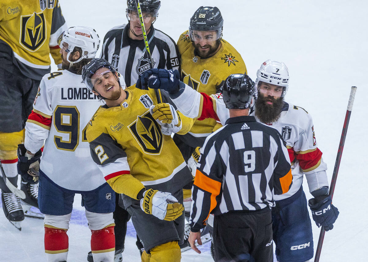 Golden Knights defenseman Zach Whitecloud (2) takes a glove to the face from Florida Panthers d ...