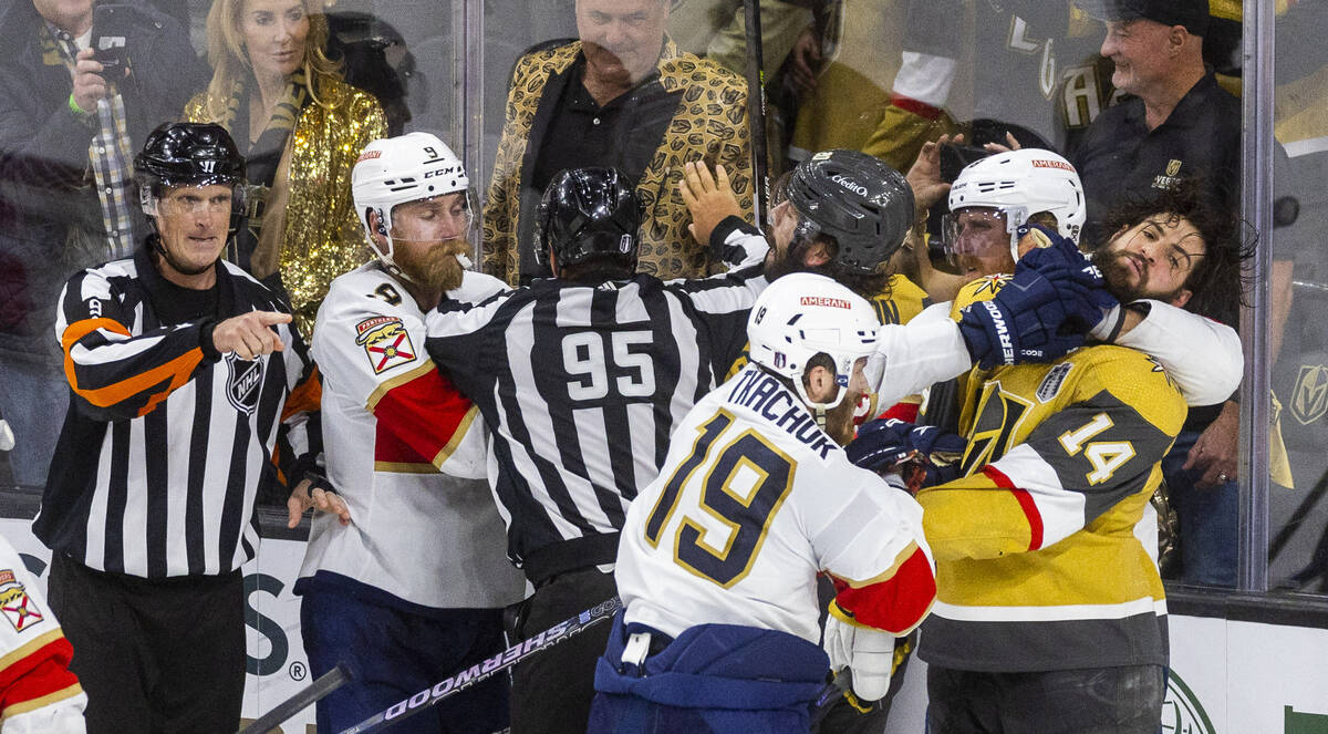 Golden Knights defenseman Nicolas Hague (14) takes a punch to the face from Florida Panthers le ...