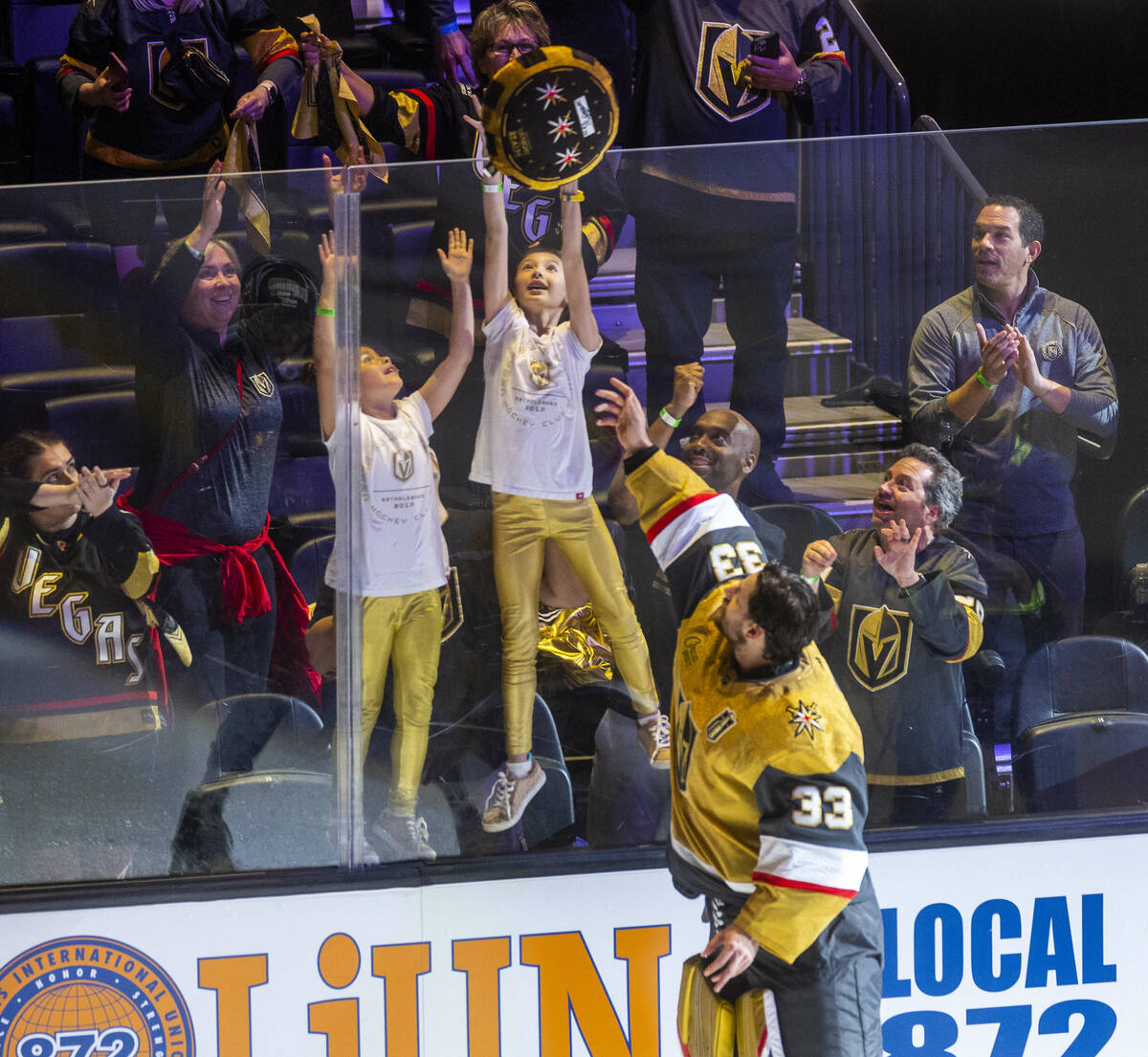 Golden Knights goaltender Adin Hill (33) tosses a giant puck to fans after defeating the Florid ...