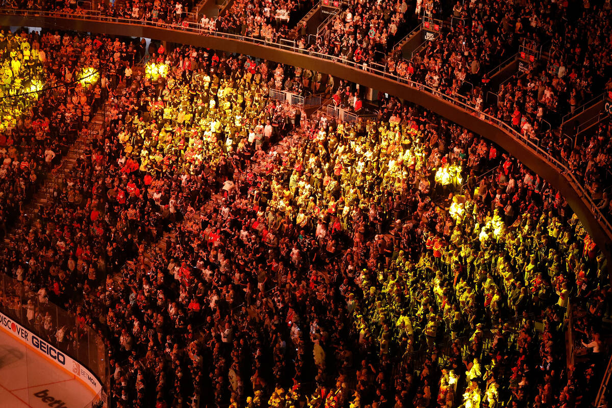 People stand up during the pre-game show before Game 1 of the NHL hockey Stanley Cup Final, Gol ...