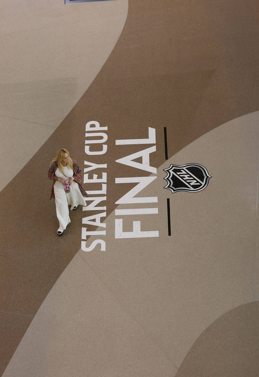 A woman walk by the sign of Stanley Cup Final during the second period in Game 1 of the NHL hoc ...