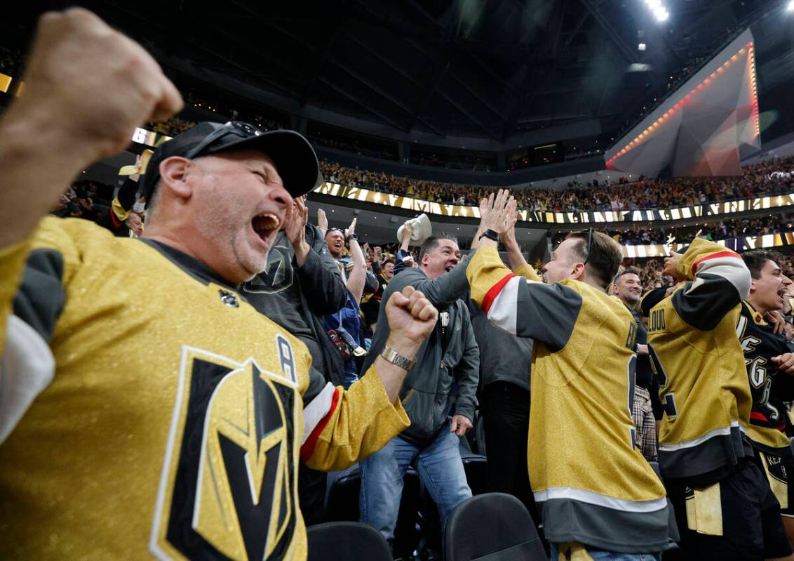 Golden Knights fans react after Golden Knights defenseman Zach Whitecloud (2) scored a goal aga ...