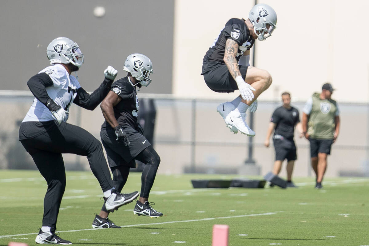 Raiders defensive end Maxx Crosby (98) leaps ahead of his teammates during the Raiders’ ...