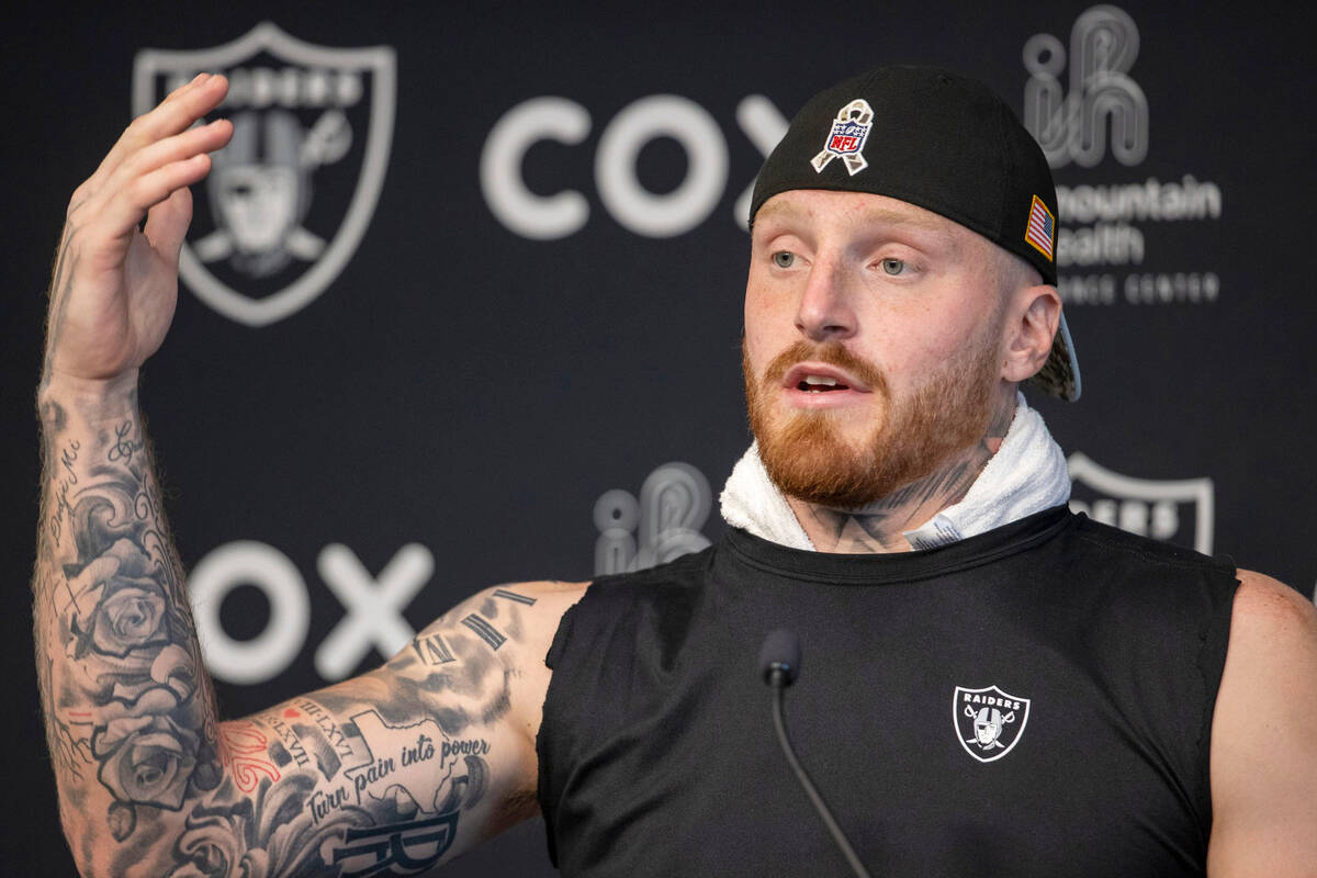 Raiders defensive end Maxx Crosby gestures as he answers a question during a news conference at ...
