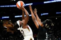 Las Vegas Aces guard Jackie Young (0) drives to the basket against Seattle Storm guard Kaila Ch ...