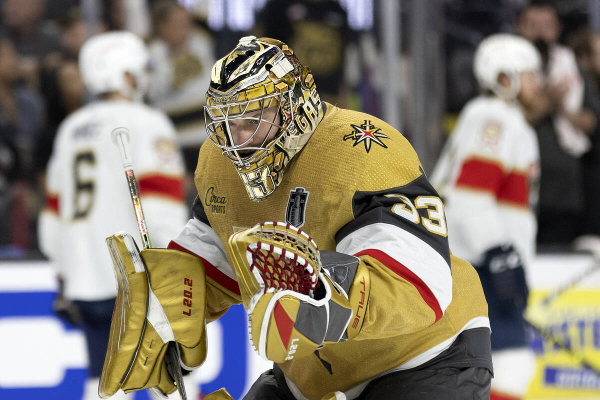 Golden Knights goaltender Adin Hill (33) practices stances while skating back to the net during ...