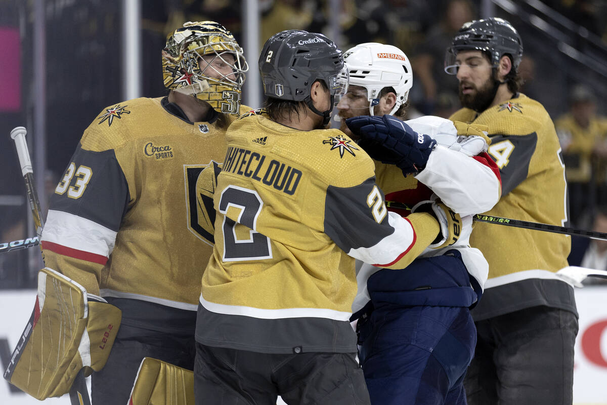 Golden Knights defenseman Zach Whitecloud (2) pushes Florida Panthers left wing Matthew Tkachuk ...
