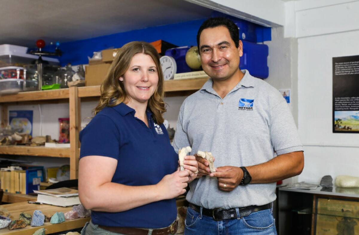 Paleontologist Becky Hall, left, is seen next to her husband, Dr. Joshua Bonde, right, at the N ...