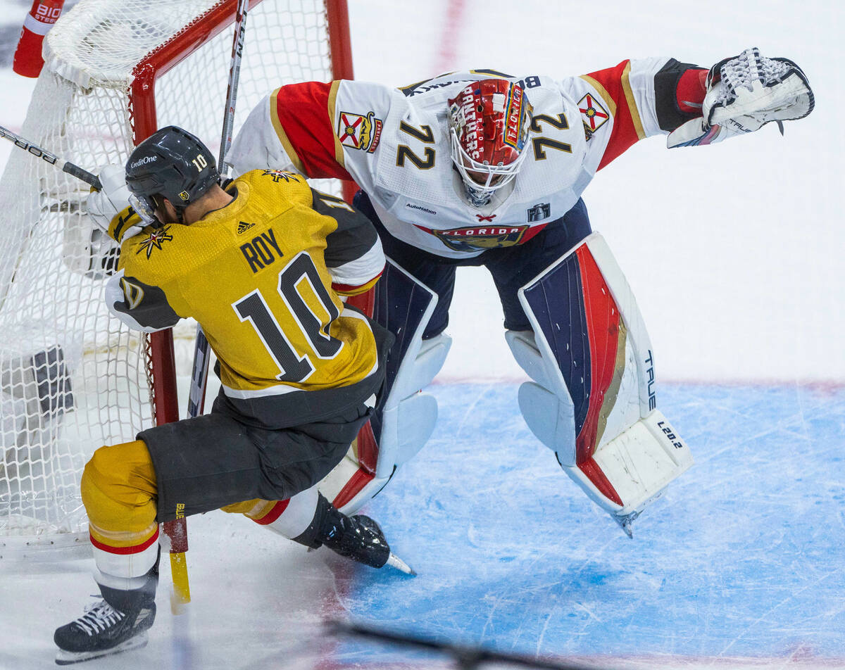 Golden Knights center Nicolas Roy (10) cis pushed into the net and Florida Panthers goaltender ...