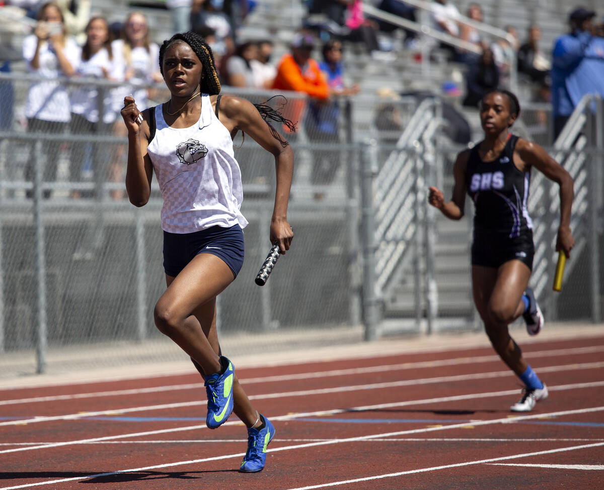 Centennial's Iyonna Codd, left, competes in the girls 4x400 race during the class 5A Southern R ...
