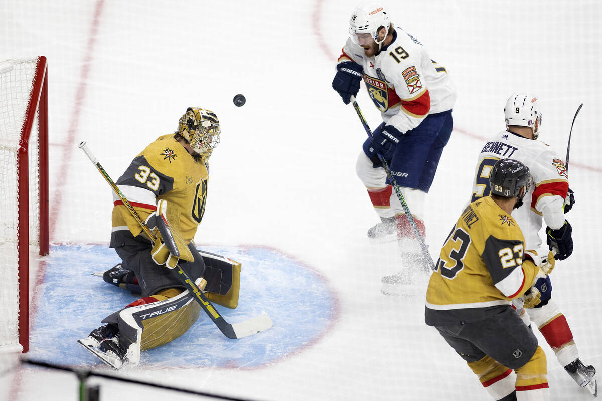 Golden Knights goaltender Adin Hill (33) saves the puck against Florida Panthers left wing Matt ...