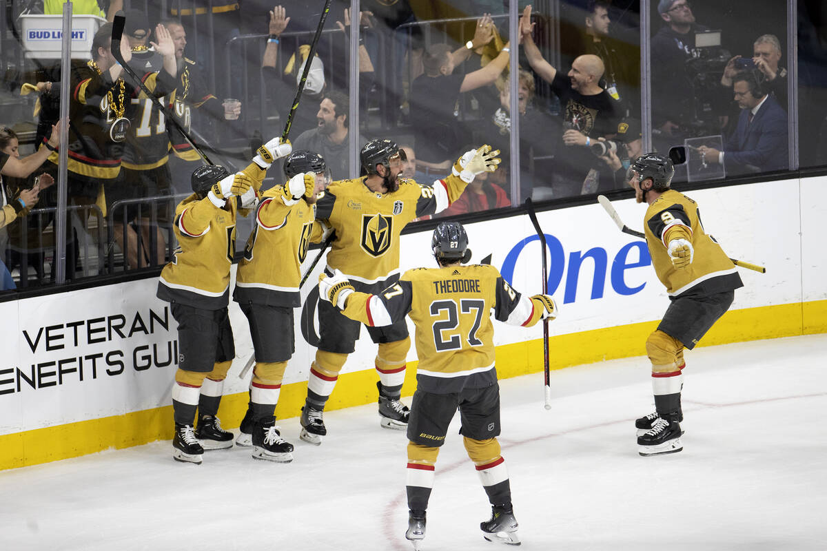 The Golden Knights surround their defenseman Alec Martinez (23) after he scored on the Florida ...
