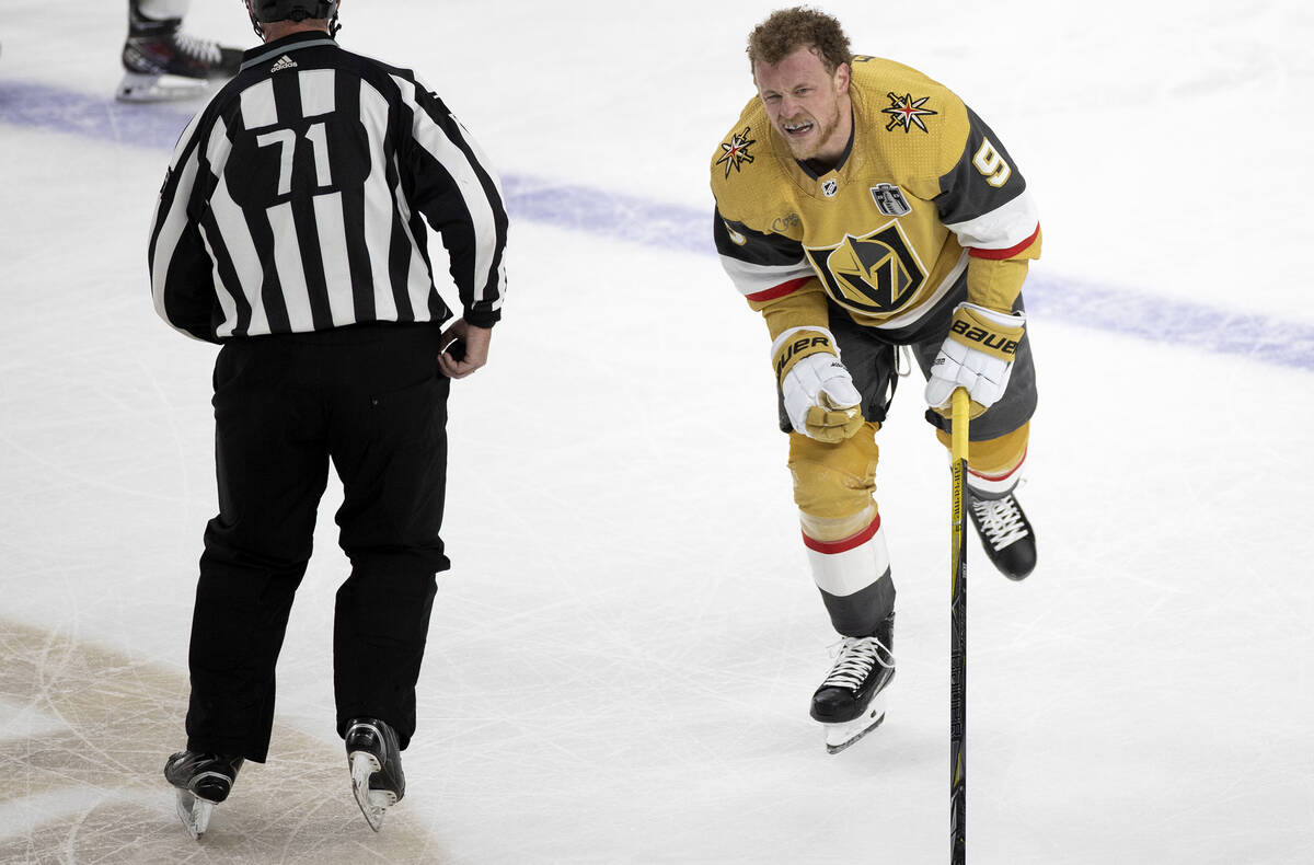 Golden Knights center Jack Eichel (9) skates off the ice from a scrum while grimacing during th ...