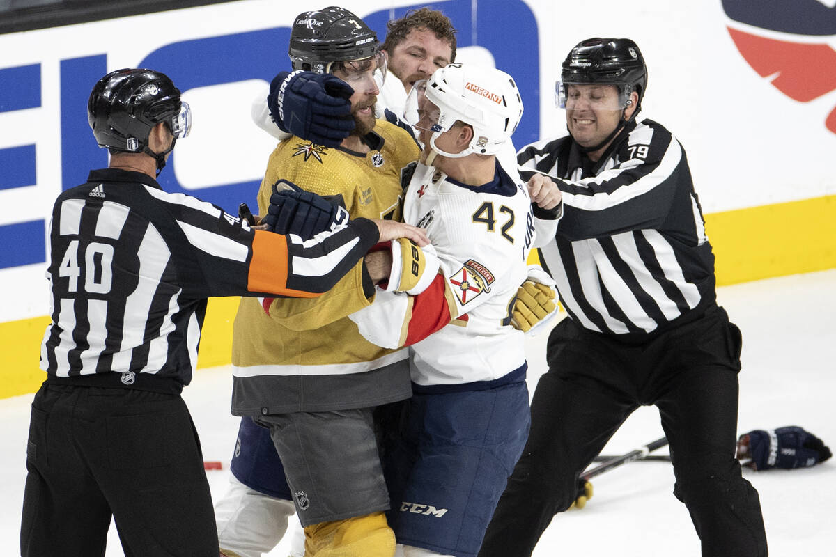 Referees attempt to separate Golden Knights defenseman Alex Pietrangelo (7) and Florida Panther ...