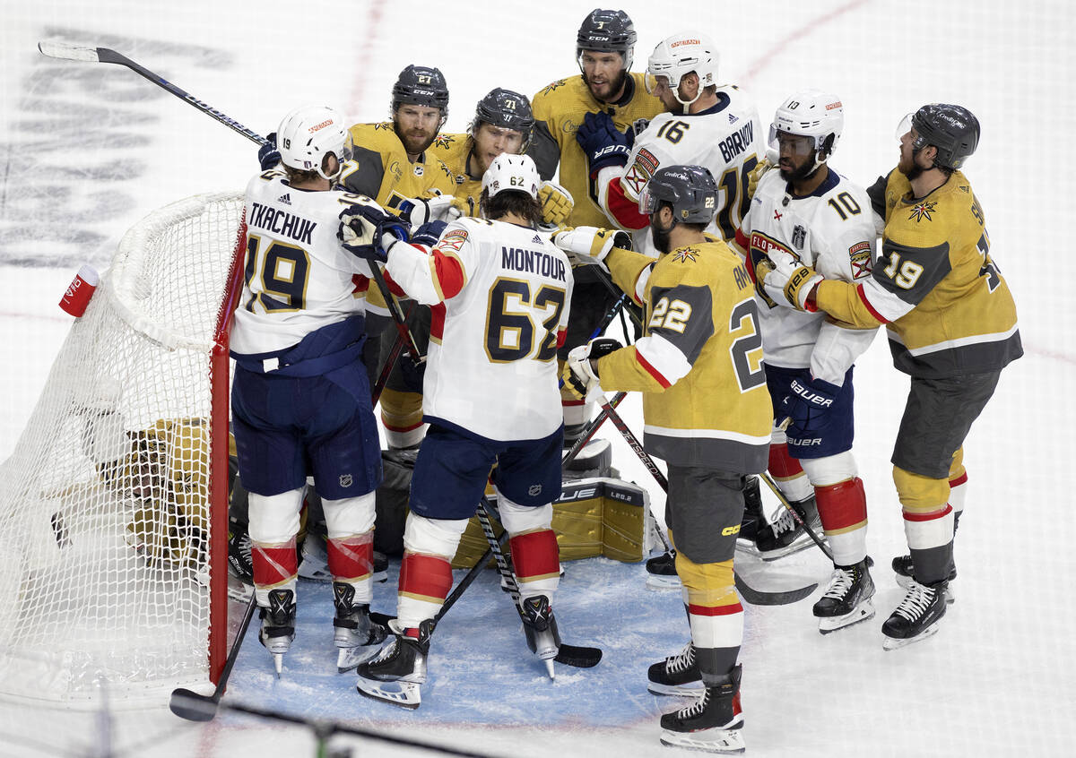 The Golden Knights and Florida Panthers form a scrum after Knights goaltender Adin Hill saved t ...