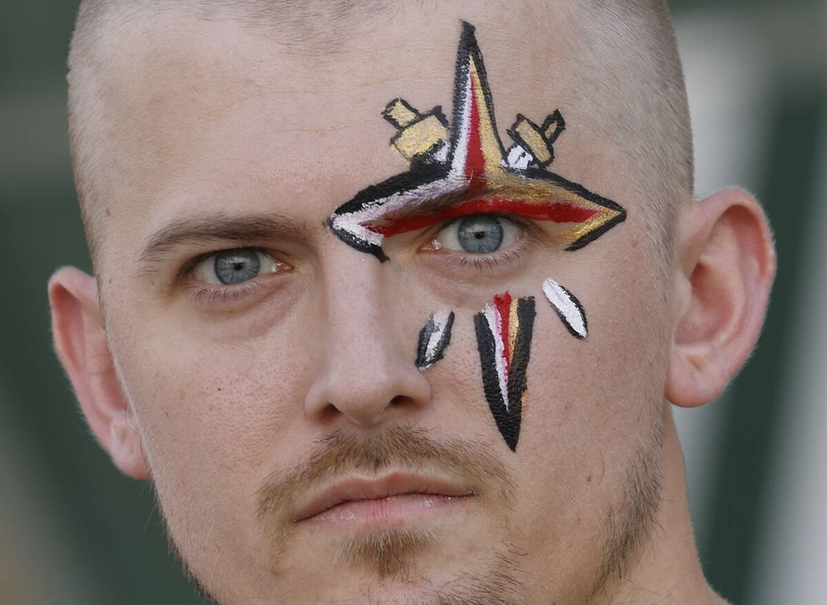 Golden Knights fan Jeff Lane of Las Vegas with his face painted in a Golden Knights symbol stan ...