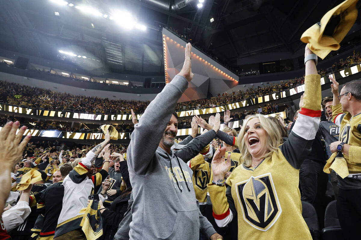Golden Knights fans Pat Treichel, left, and wife Kerry celebrate a first period goal against th ...