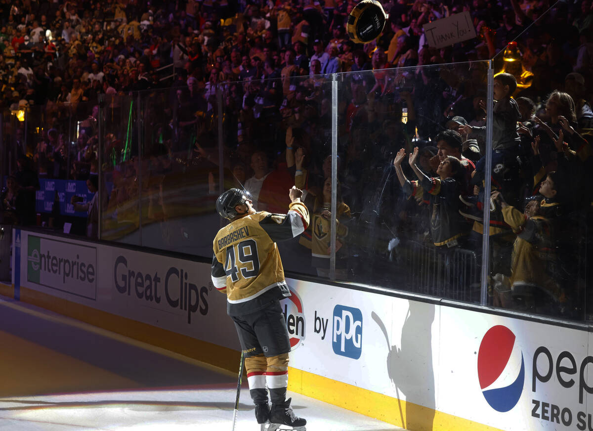 Golden Knights center Ivan Barbashev (49) tosses a giant puck to fans after their 7-2 victory a ...