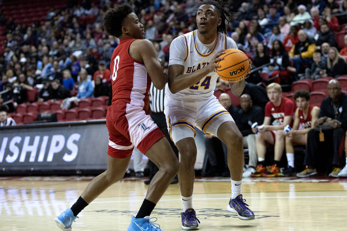 Durango’s Taj Degourville (24) looks to shoot against Liberty’s Tyus Thomas (0) d ...