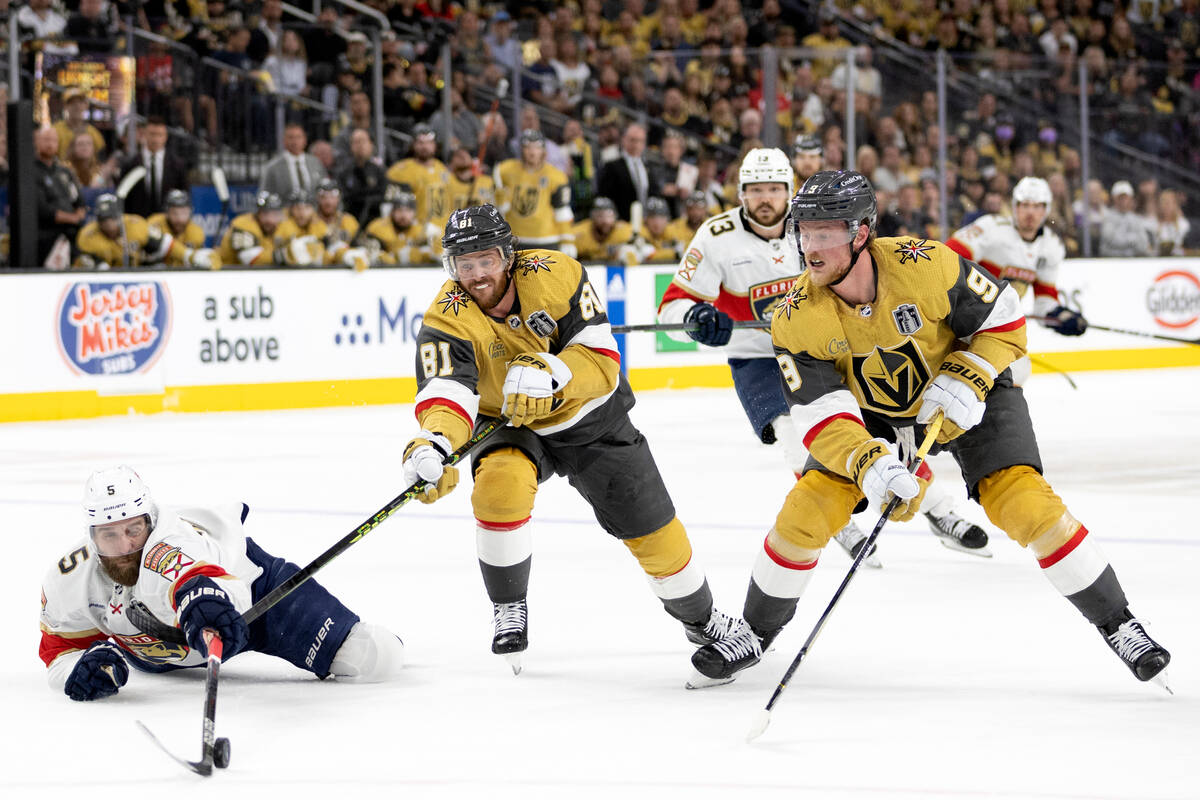Florida Panthers defenseman Aaron Ekblad (5) reaches for the puck against Golden Knights right ...
