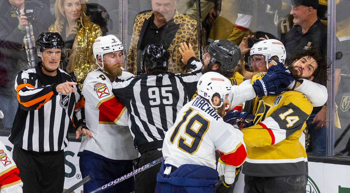 Golden Knights defenseman Nicolas Hague (14) takes a punch to the face from Florida Panthers le ...