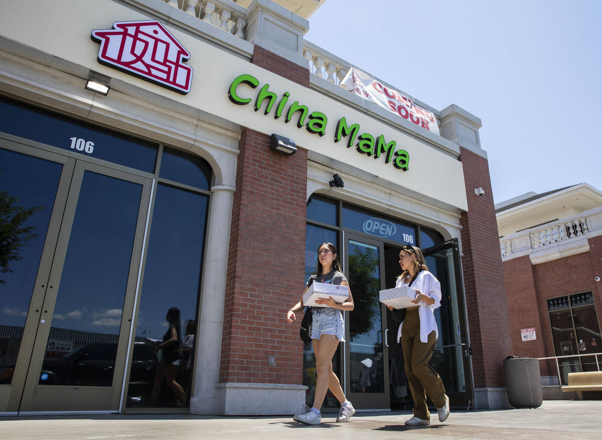 People walk in front of the new location for China Mama in the Shanghai Plaza, where the restau ...