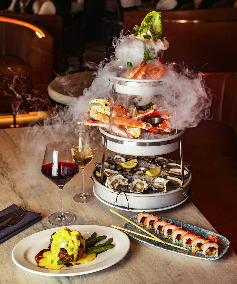 The Smoking Shellfish Tower, a custom built tower of mixed seafood, next to the Filet Oscar Sty ...