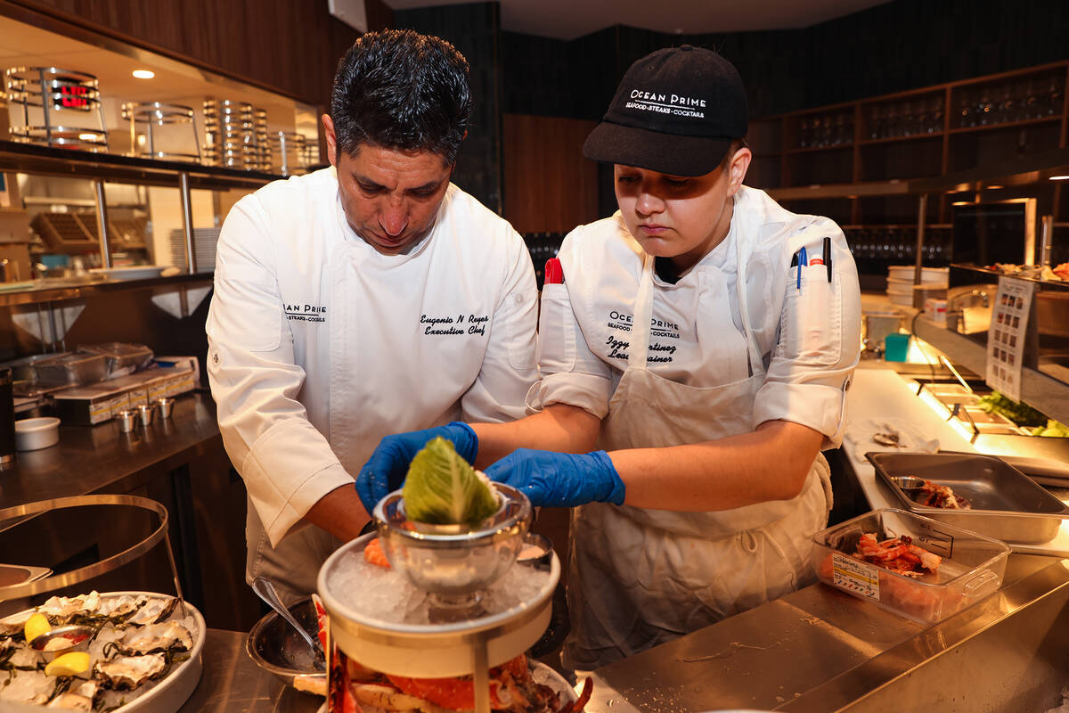 Executive Chef Eugenio Reyes, left, and Izzy Martinez, right, a lead trainer, puts together th ...