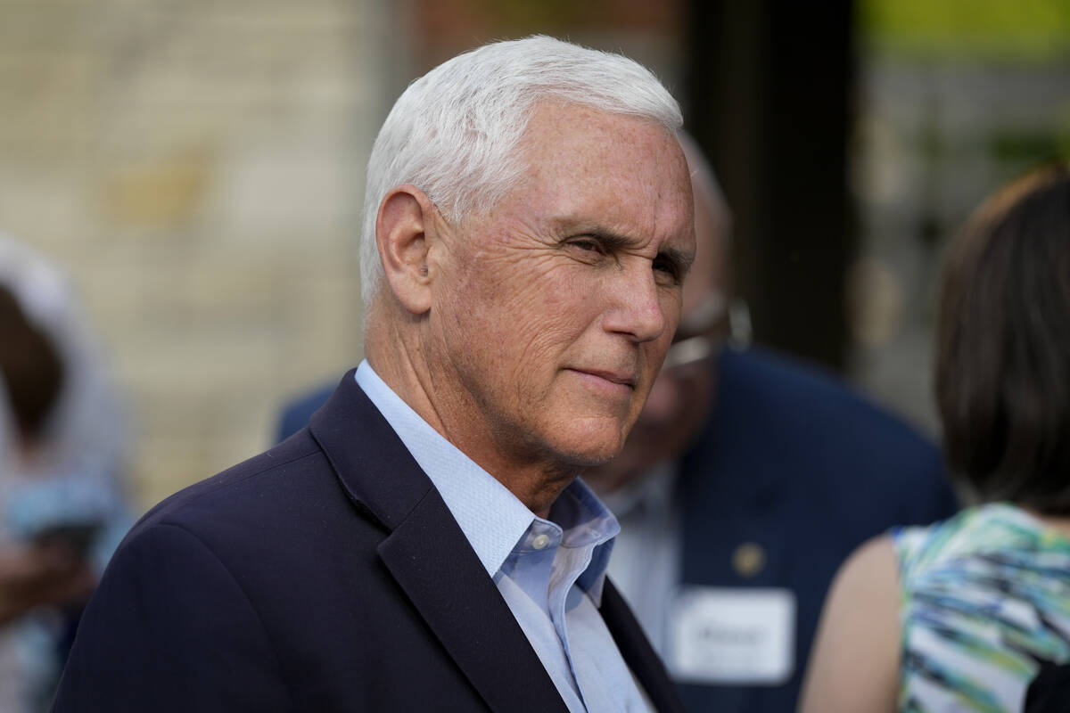 FILE - Former Vice President Mike Pence talks with local residents during a meet and greet on M ...