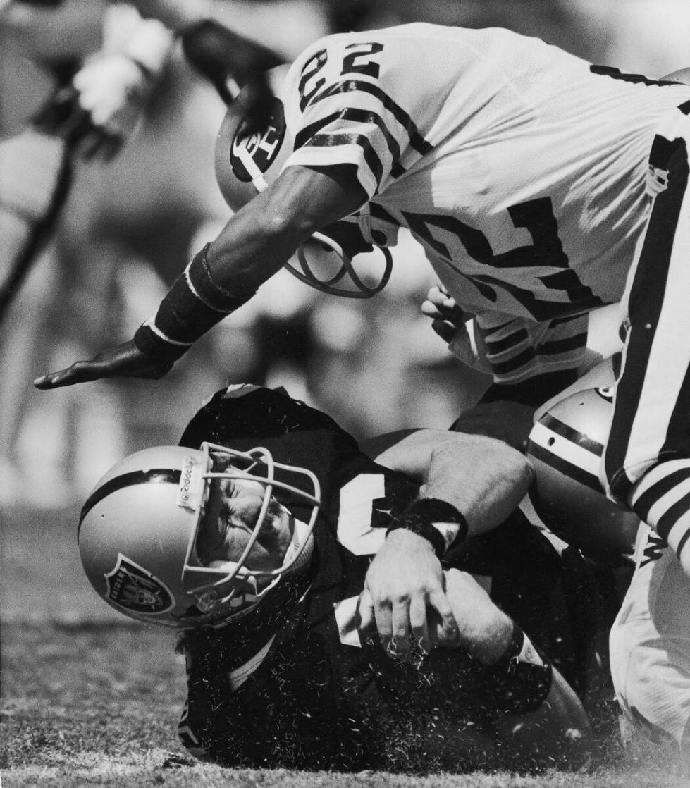 San Francisco 49ers Dwight Hicks (22) is about to land on Los Angeles Raiders Todd Christensen ...