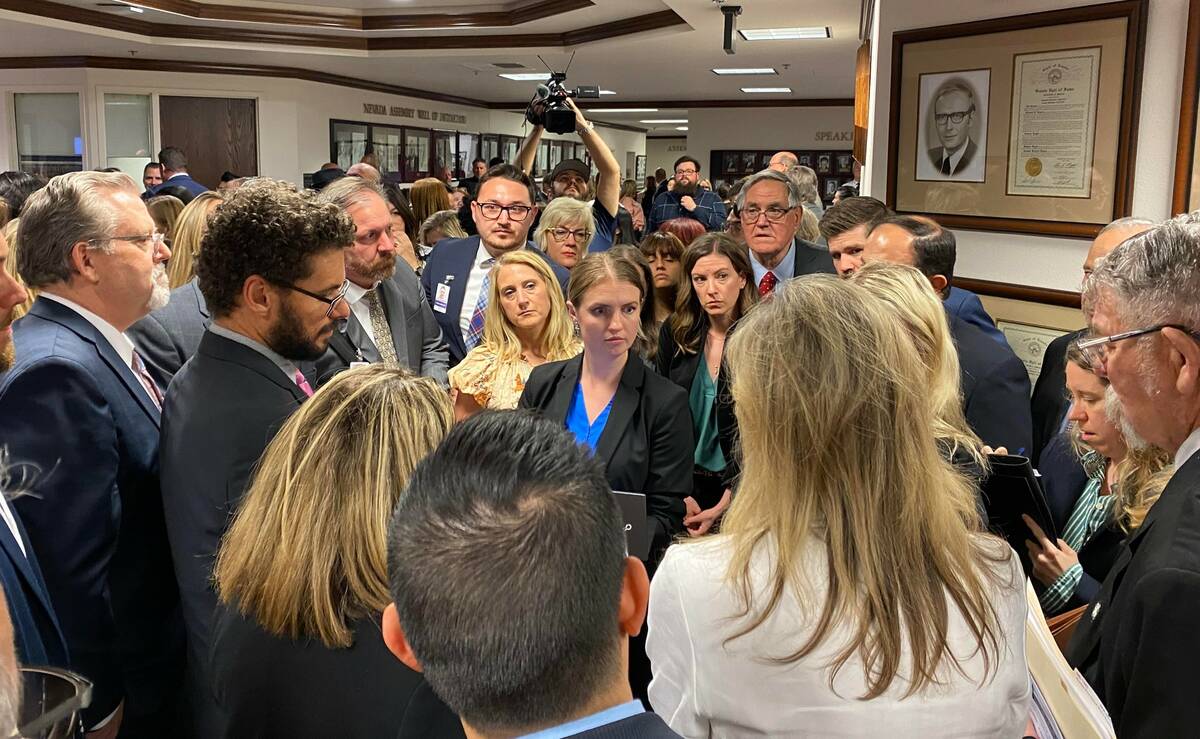 Lawmakers, lobbyists and members of the press gather in the Nevada Legislature building for a c ...