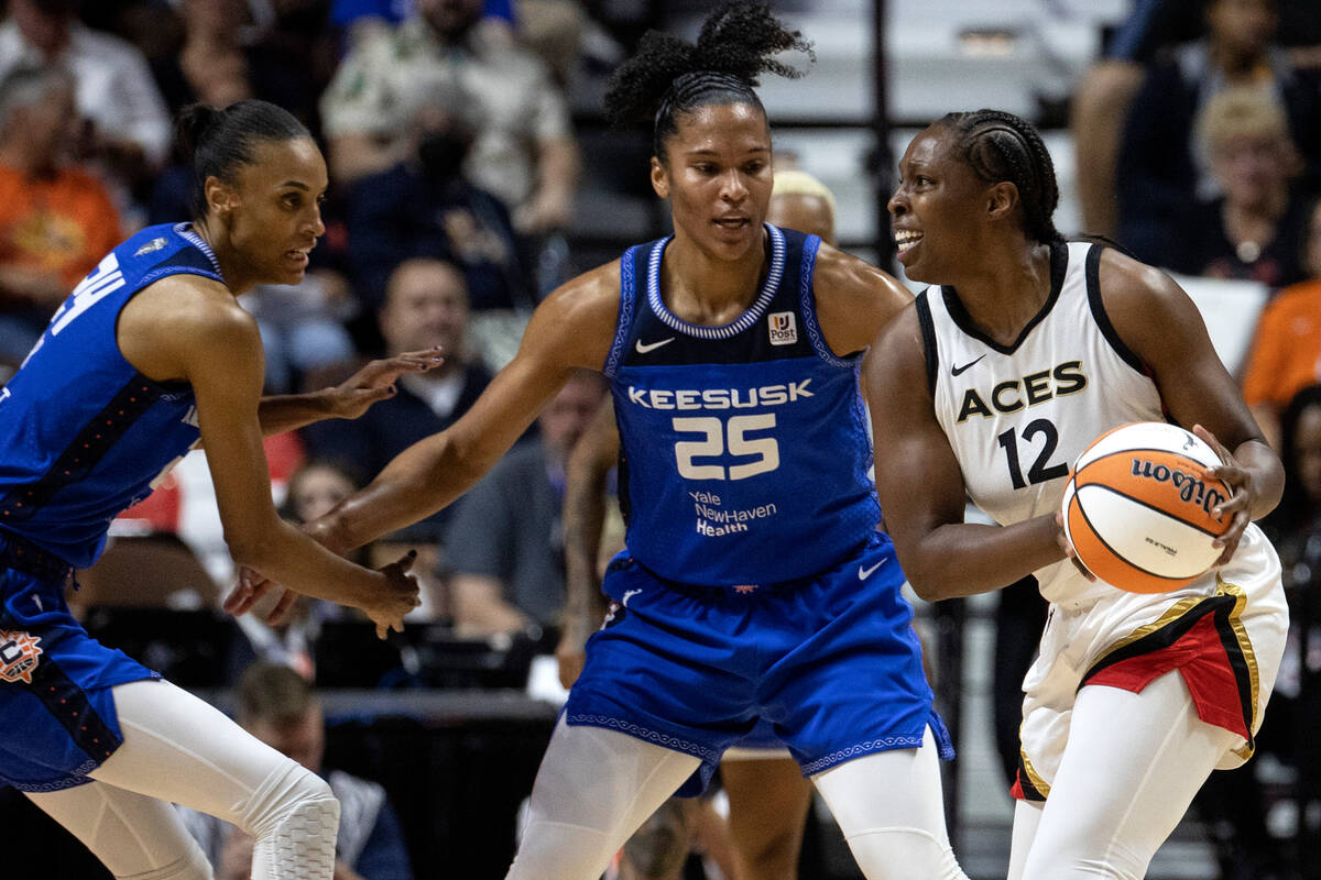 Las Vegas Aces guard Chelsea Gray (12) looks to pass while Connecticut Sun forward DeWanna Bonn ...