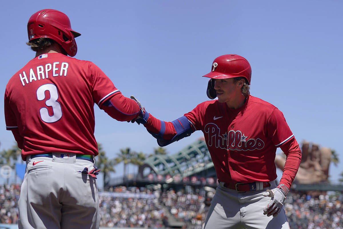 Philadelphia Phillies' Bryson Stott, right, is congratulated by Bryce Harper (3) after hitting ...