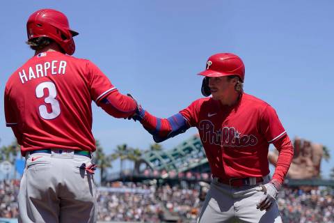 Philadelphia Phillies' Bryson Stott, right, is congratulated by Bryce Harper (3) after hitting ...